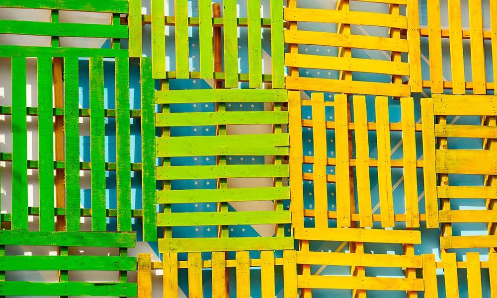 Painted wood pallets in green and yellow for brand identification